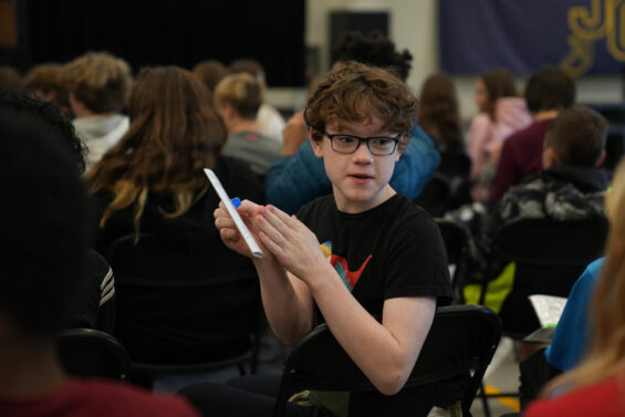 Kansas High School Student clapping during an assembly