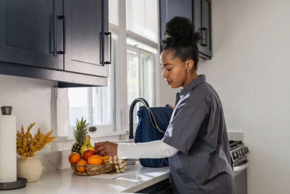 Young professional packs lunch in her new Kansas home