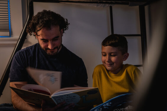 Father reads a book to his son