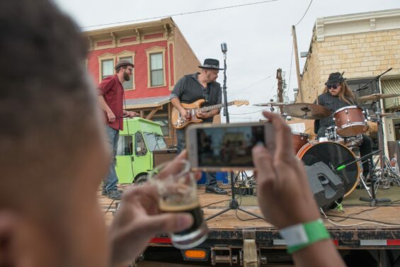 A man recording performers at a Kansas music festival
