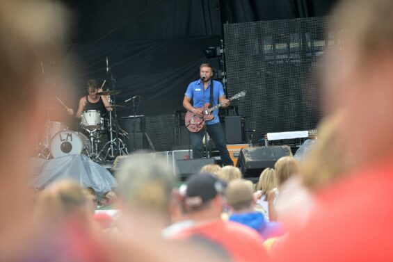 Country singer playing the electric guitar on stage at a live show